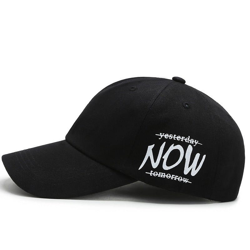 Four seasons baseball cap featuring embroidered text 'yesterday NOW tomorrow' in white on black fabric.