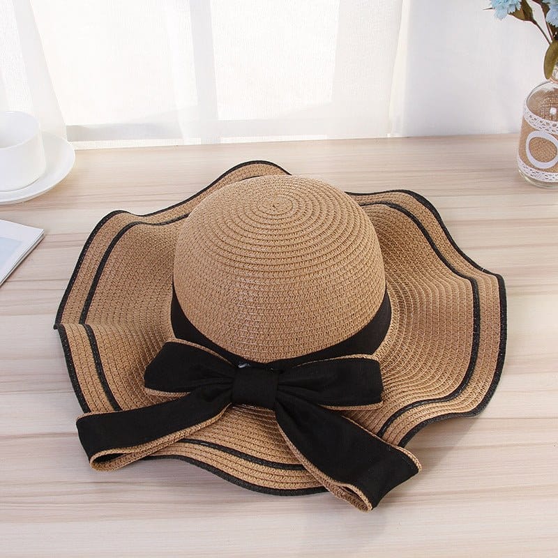 Stylish beach hats for women with a black bow, perfect for sun protection and fashionable beach outings.