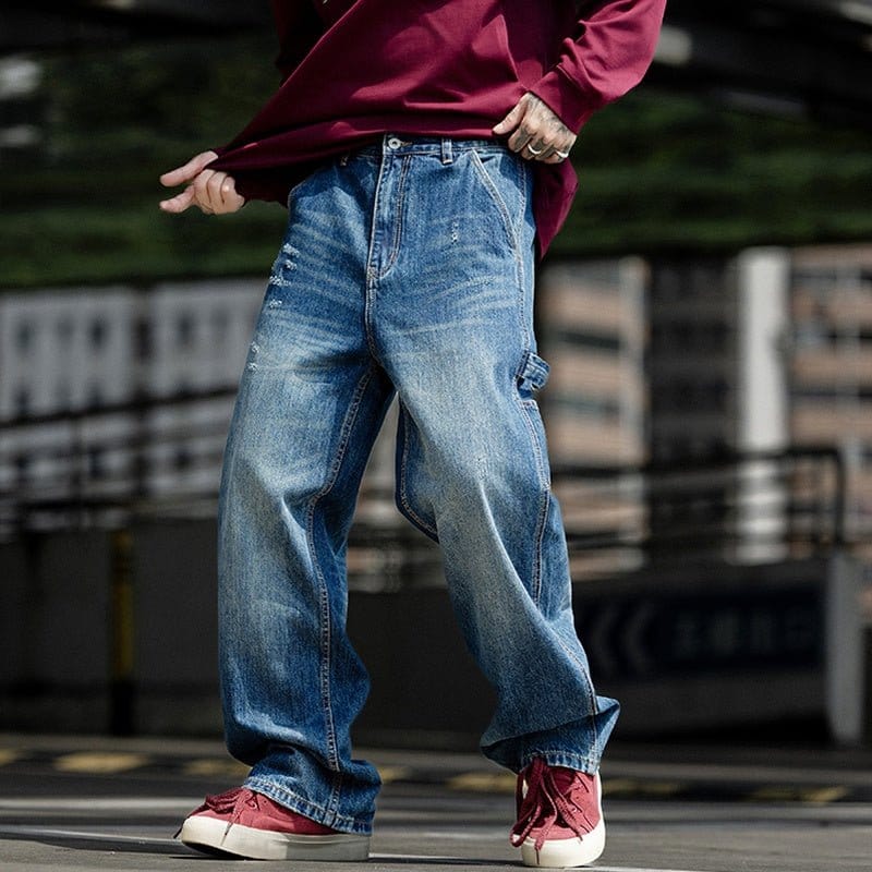 Man wearing denim jeans and red sneakers, showcasing a casual street style look.