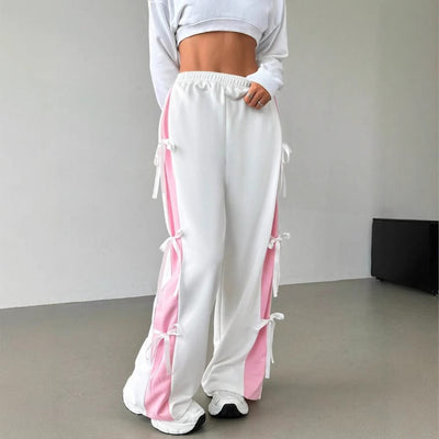 Women's elastic waist trousers in white and pink with loose fit and straight-leg style.