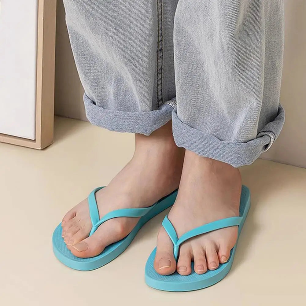 Summer non-slip flip flops in light blue worn with rolled-up jeans, perfect for casual outings or home use.