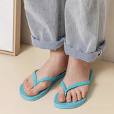 Summer non-slip flip flops in light blue worn with rolled-up jeans, perfect for casual outings or home use.