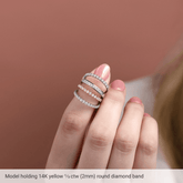 Model showcasing a diamond anniversary band in 14K yellow gold with sparkling round diamonds.