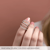 Model showcasing a diamond anniversary band in 14K yellow gold with sparkling round diamonds.