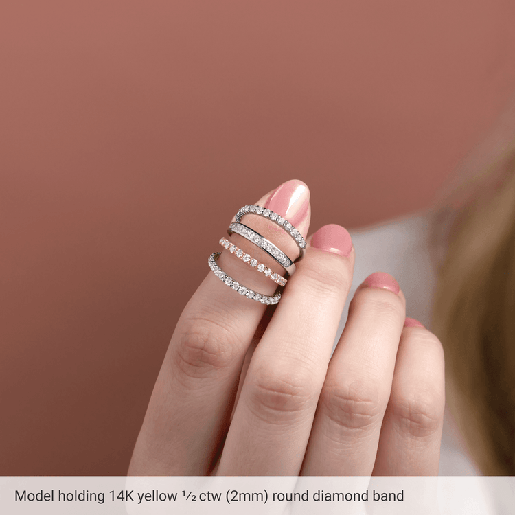 Model showcasing a diamond anniversary band in 14K yellow gold with sparkling round diamonds.
