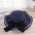 Stylish beach hats for women, navy blue straw hat with black bow, perfect for sun protection and summer outings.