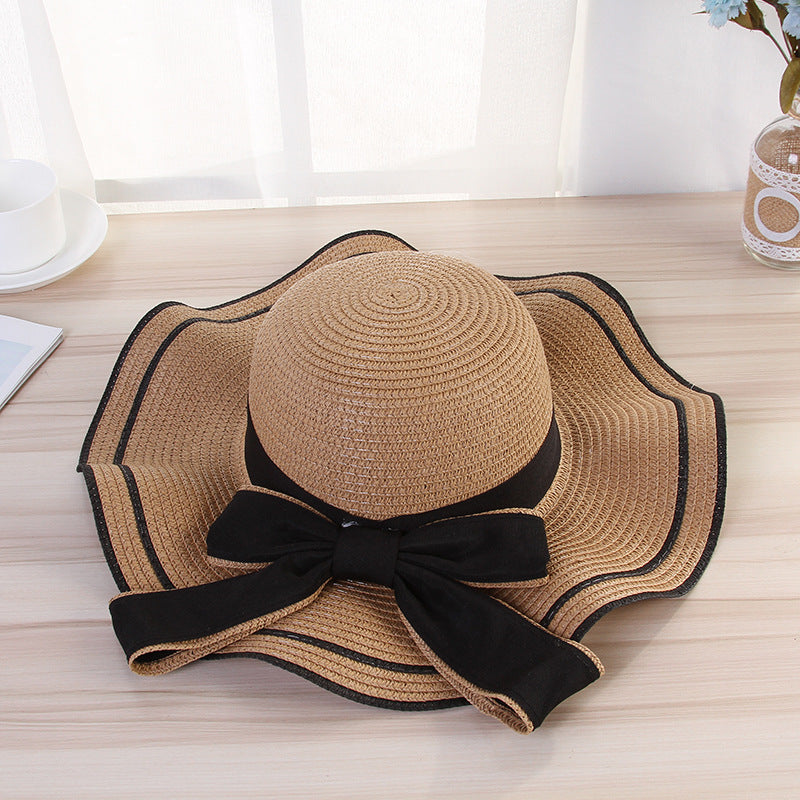 Stylish beach hats for women with a black bow, perfect for sun protection and fashionable beach outings.