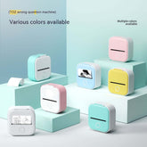 Portable mini label printer in various colors displayed on blocks, showcasing its compact design and Bluetooth compatibility.