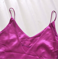 V-neck harness dress in bright purple satin fabric with delicate straps and a luxurious sheen.