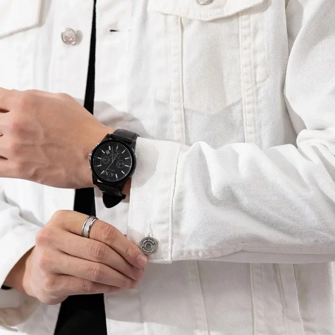 Man wearing a well-fitting formal denim jacket with a watch on his wrist.