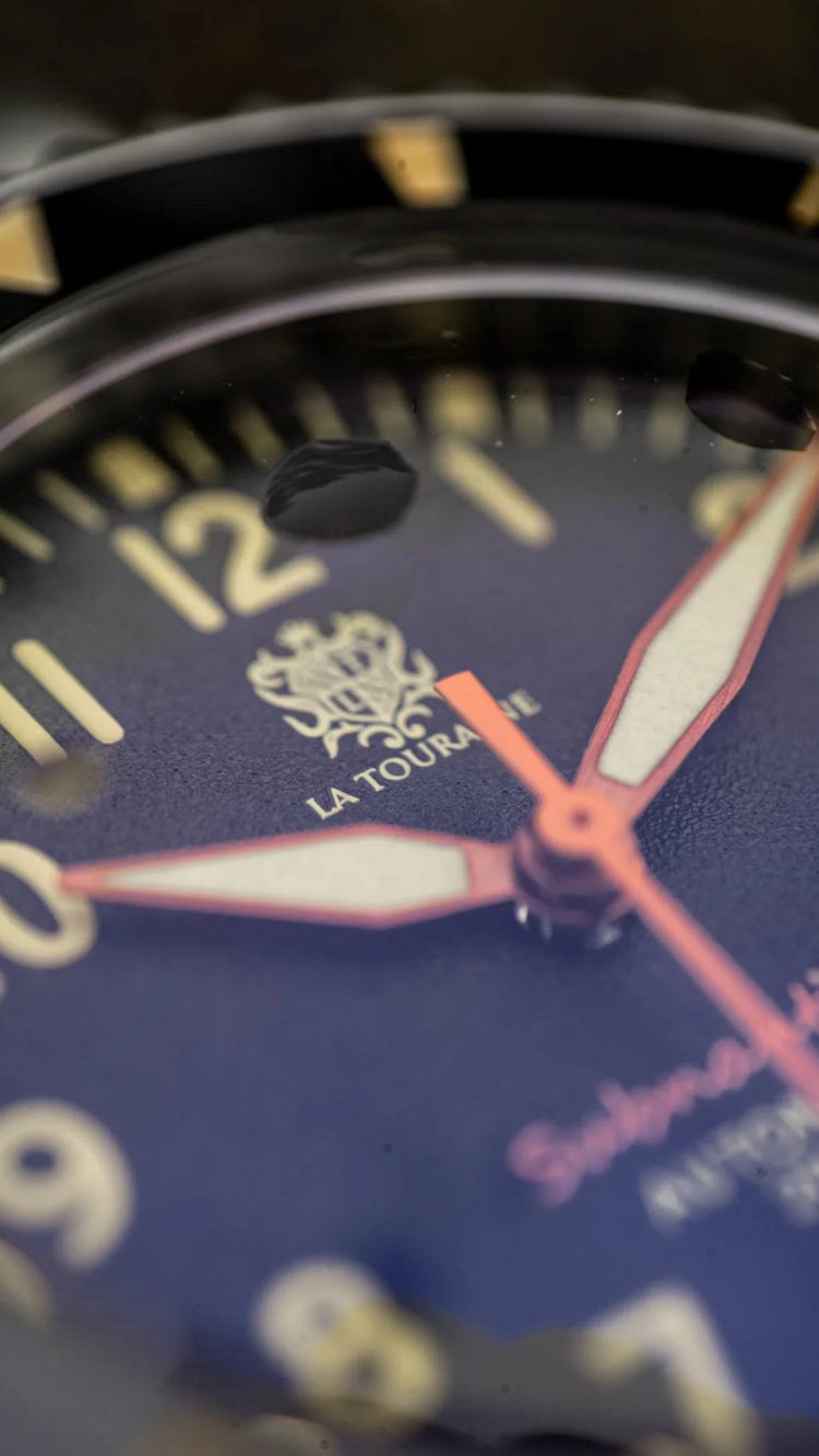 Close-up of Subnautica Automatic Diver Watch dial showcasing the brand logo and detailed design elements.