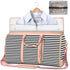 Large capacity travel duffle bag shown with clothes inside, featuring stylish black and white stripes and a convenient design.