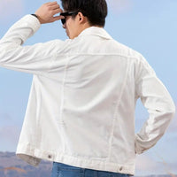 Man wearing a well-fitting formal denim jacket, showcasing its stylish back design outdoors.