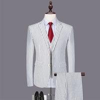 striped three-piece suit for men displayed with a red tie and black shoes, showcasing a fashionable urban style.