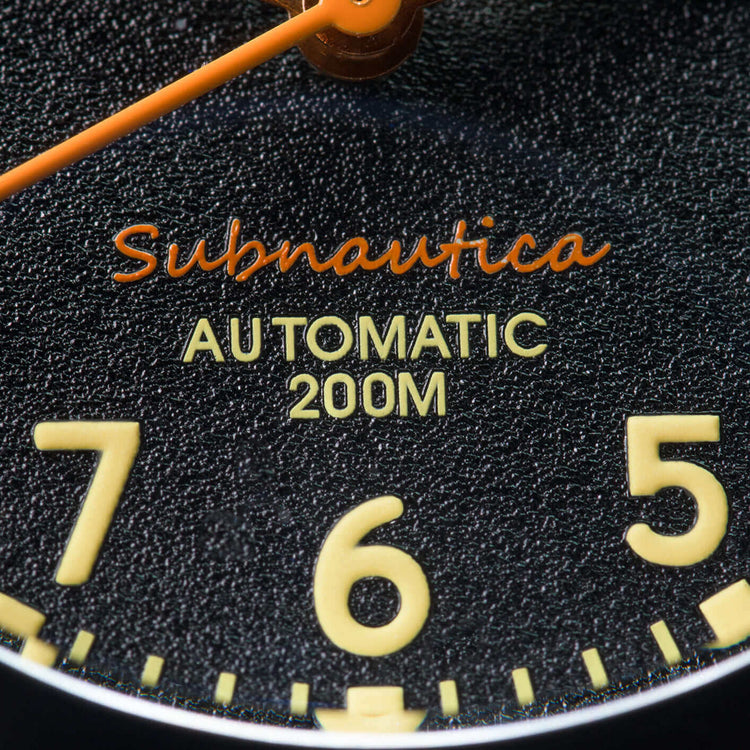 Close-up of the Subnautica Automatic Diver Watch dial showcasing the automatic feature and depth rating.