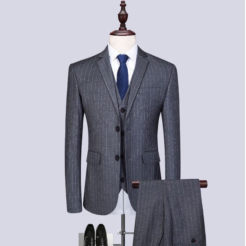 Stylish gray striped three-piece suit for men displayed on a mannequin with shoes, perfect for formal occasions.