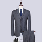 Stylish gray striped three-piece suit for men displayed on a mannequin with shoes, perfect for formal occasions.