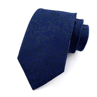 Mens jacquard woven business casual tie in dark blue with floral jacquard pattern and arrow-shaped design.