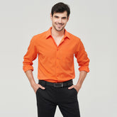 W7 business shirt polyester in vibrant orange color, worn by a smiling man with dark hair.