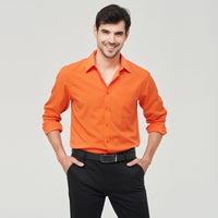 W7 business shirt polyester in vibrant orange color, worn by a smiling man with dark hair.