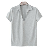 Mens breathable v-neck short-sleeve top in gray displayed on a wooden hanger.