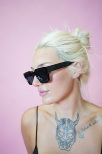 Color Shades - Teddy in black worn by model against a pink background, showcasing edgy style and sleek lines.