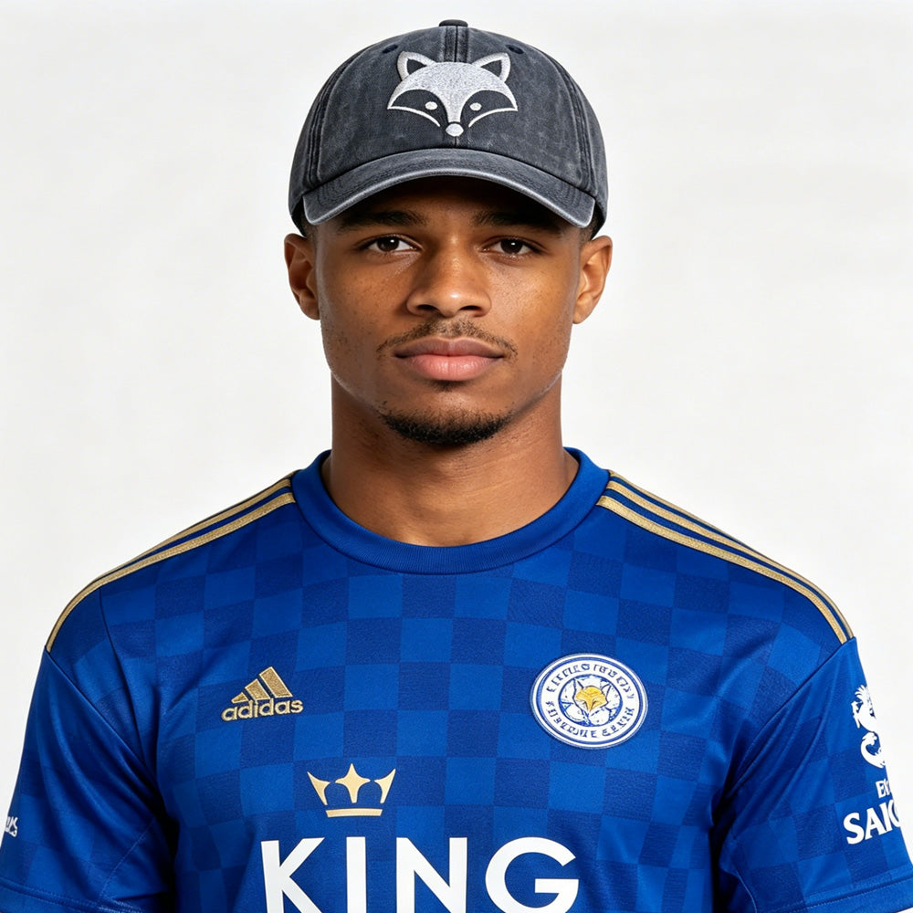 A model wearing a fox embroidered baseball cap with a Leicester City jersey, showcasing the playful design.