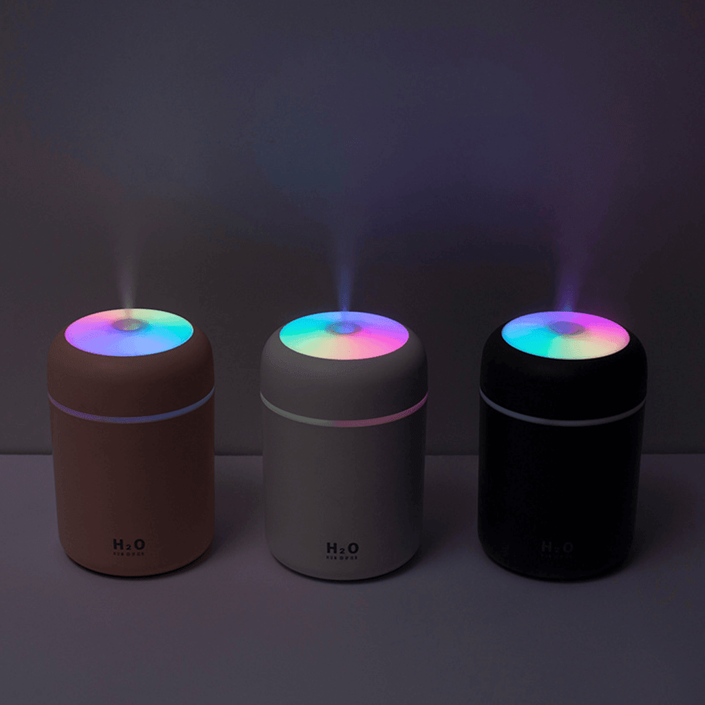 Portable aroma essential oil diffuser in three colors with colorful night light and mist feature.