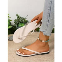 Women's casual beach flip-flops being worn with an anklet, featuring a solid color design.